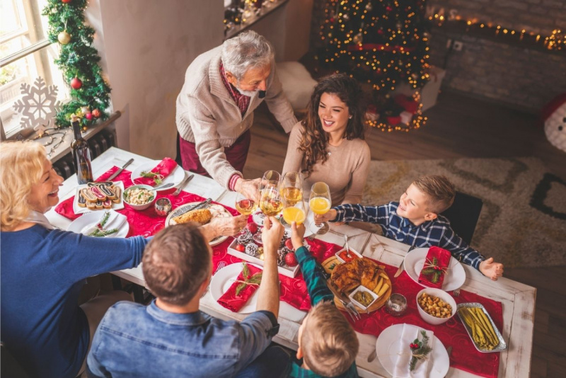 festa di natale tavola imbandiuta famiglia felice brindisi nonni pap mamma figli decorazioni
