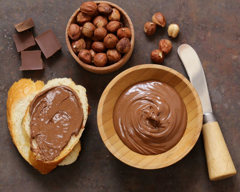  crema nocciole cioccolato fondente ciotola legno coltello fetta di pane