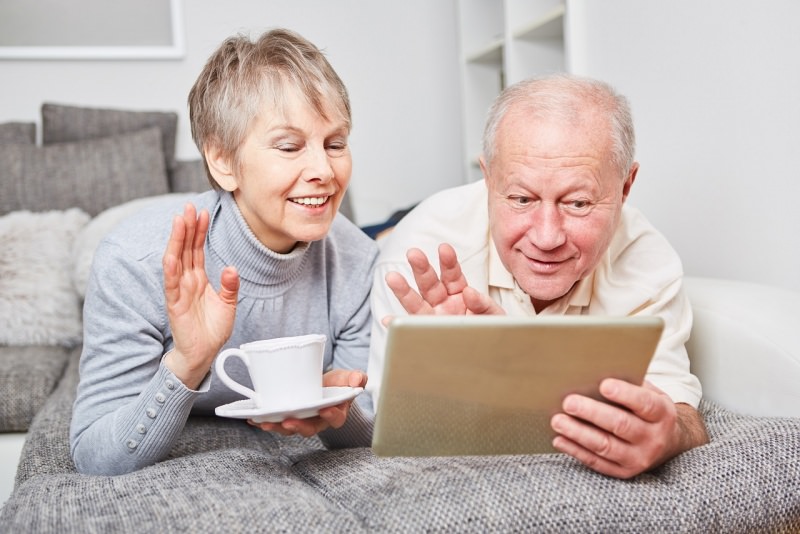 coppia anziani nonno nonna chattano tablet tazzina te caff divani