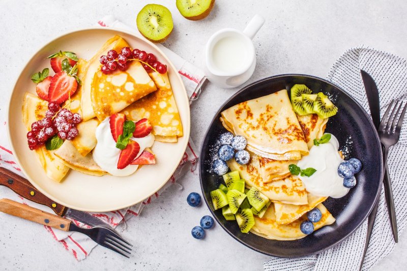 crpes dolci con frutta mirtilli kiwi fragole ribes panna zucchero a velo piatto padella