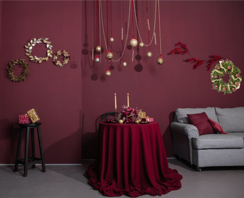 salotto pareti bordeaux decorazioni natalizie oro rami 