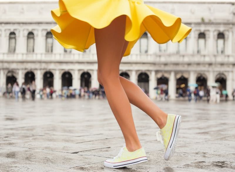 donna felice gonna giallo e sneakers gialle gambe stile