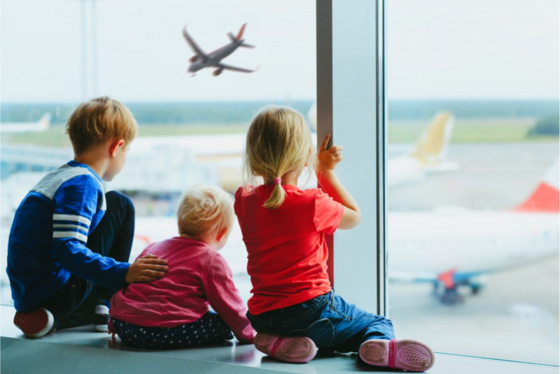 bambini seduti guardano partenza aereo aeroporto viaggiare capelli biondi bambino bambina