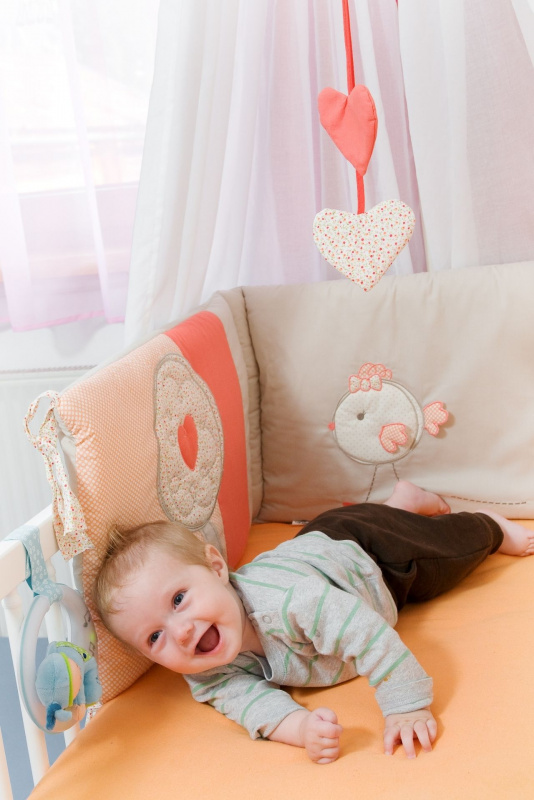 bambino bello sdraiato nella culla lettino con lenzuola
