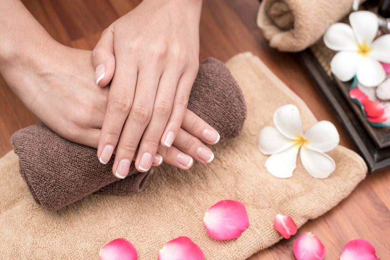 belle mani con perfetta manicure spugna petali rose rosa fiore bianco