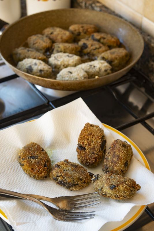 preparazione polpette di melanzane fritte in padella piatto carta assorbente