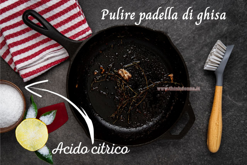 padella di ghisa sporca residui cibo incrostato spazzola per pentole strofinaccio strisce bianco rosso ciotola acido citrico fetta di limone foglie verdi