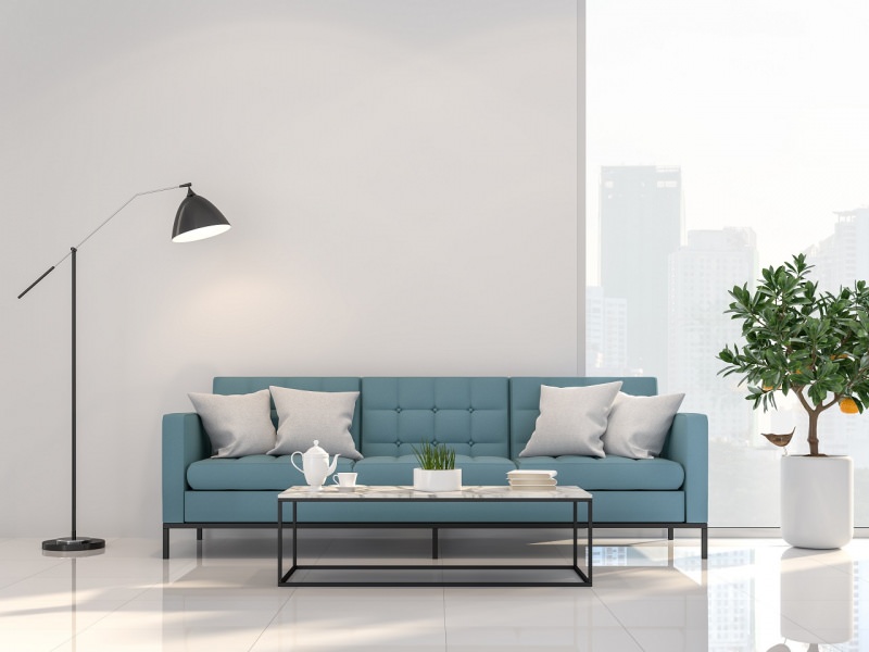 divano azzurro tavolo lampada soggiorno stile minimal cuscini