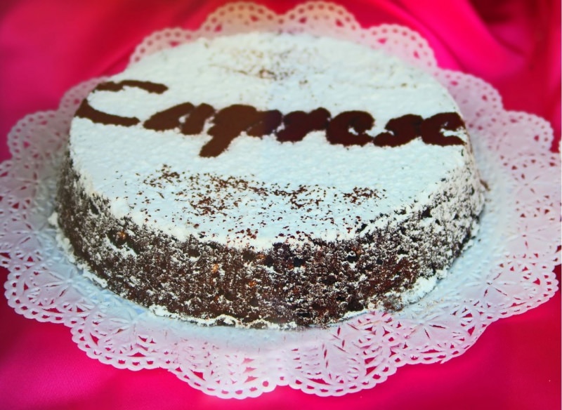 La torta caprese  una tradizionale torta italiana al cioccolato e mandorle o noci zucchero a velo che prende il nome dall'isola di Capri da cui ha avuto origine centrino bianco