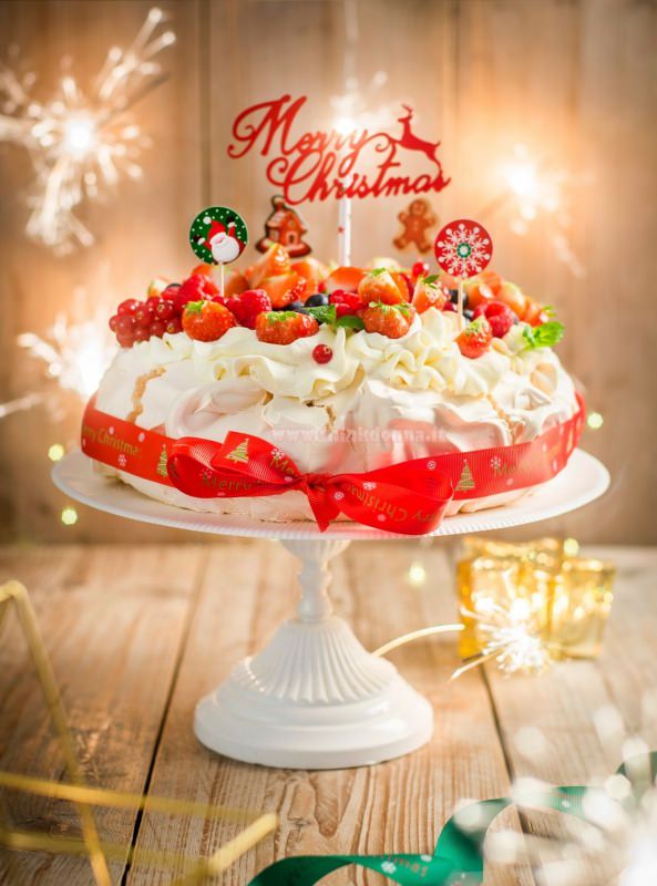 torta pavlova di natale scritta merry christmas alzatina ceramica bianca meringa panna montata nastro rosso luci led