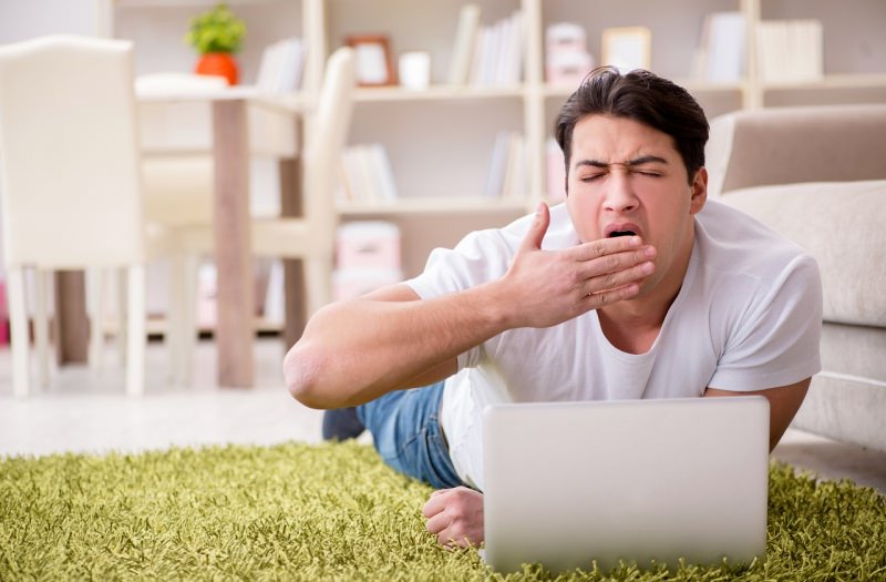 uomo sdraiato sul tappeto soggiorno casa laptop smart working lavoro da casa