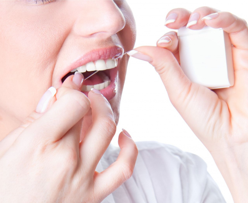 buona igiene orale con filo interdentale sorriso denti bianchi donna